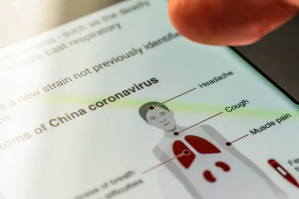 Coronavirus covid 19 wuhan text on smart phone screen - Northampton, Uk - February 25, 2020 — 스톡 사진