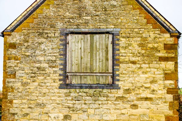 Janela velha na parede de pedra construção textura em inglaterra uk — Fotografia de Stock