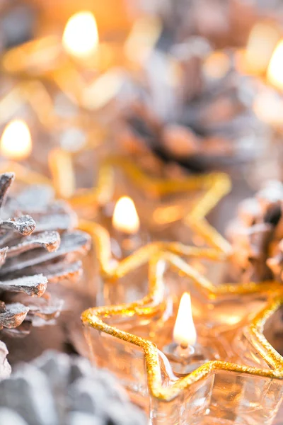 Christmas. Christmas card with glowing small candle and fir cone — Stock Photo, Image