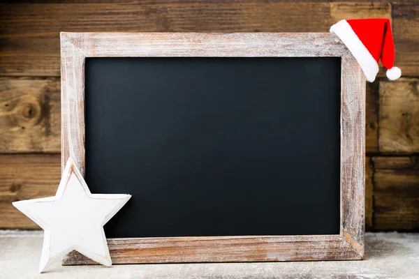 Christmas chalkboard with decoration. Santa hat, stars,  Wooden — Stock Photo, Image