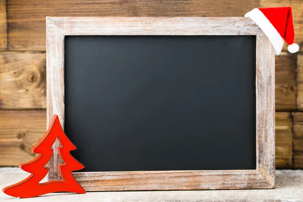 Christmas chalkboard with decoration. Santa hat, stars,  Wooden — Stock Photo, Image