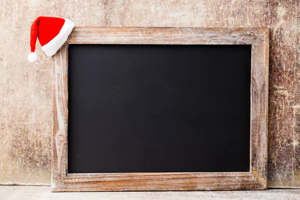 Christmas chalkboard and decoration over wooden background. — Stock Photo, Image