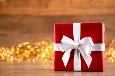 Kurdeleli Noel hediye kutuları ve bokeh arka planında ağaç..