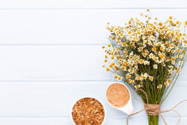 Doğal kozmetik ürünleri ve açık arkaplanda papatya çiçekleri ile kompozisyon aroması.