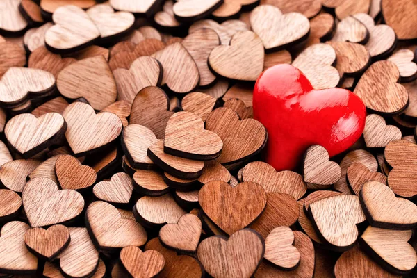 Wooden hearts pattern, one red heart on the wooden heart background.