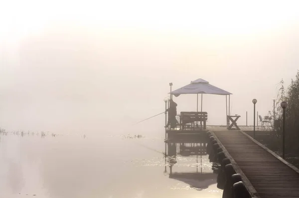 Pêcheur sur le quai dans la matinée brumeuse — Photo