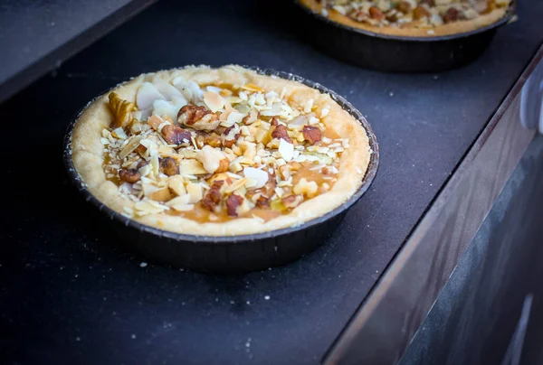 Round dessert with nuts, on a dark background. — Stock Photo, Image