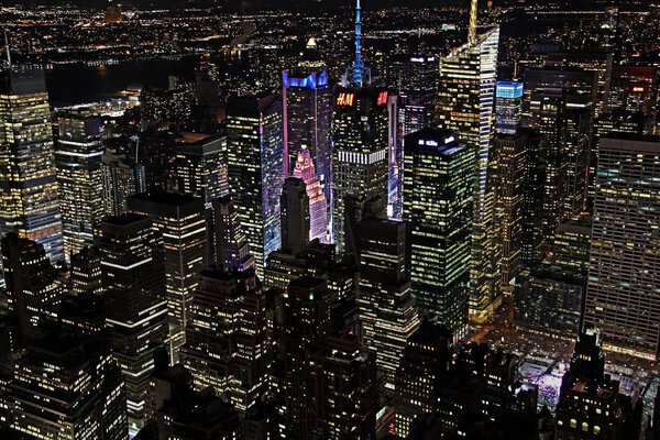 New York City nighttime skyline containing extended view with buildings lit up