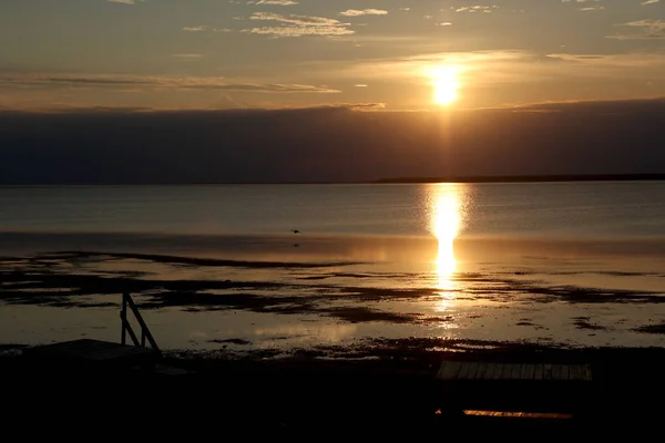 Sole che tramonta su una spiaggia con bassa marea — Foto Stock