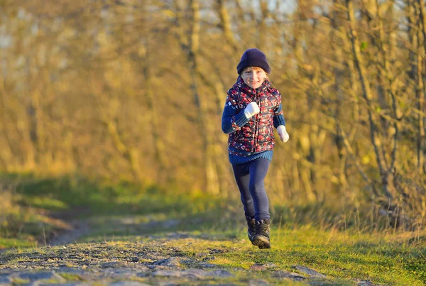 Little girl running in sunlight — Stock Photo, Image