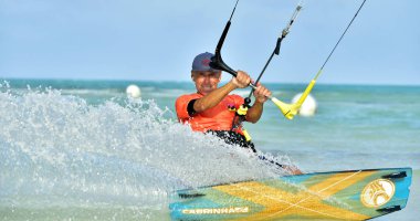 Cayo Guillermo, Cuba - December 17 2017: Man riding his kiteboard on Cayo Guillermo in Atlantic Ocean, Enjoy kite surfing. December 2017 in Cuba. Caya Guillermo is a popular beach for kitesurfing. clipart