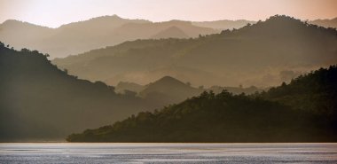 Twilight before sunrise on the ocean coast. Ocean and mountains Landscape at the foggy morning. Komodo Island. Moluccas, Indonesian Maluku, Spice Islands, Indonesian islands, Malay Archipelago. clipart