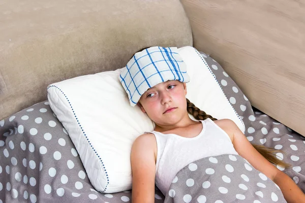 Girl with heatstroke lying in bed. — Stock Photo, Image