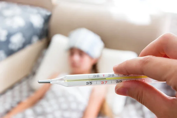 Girl with heatstroke lying in bed. — Stock Photo, Image