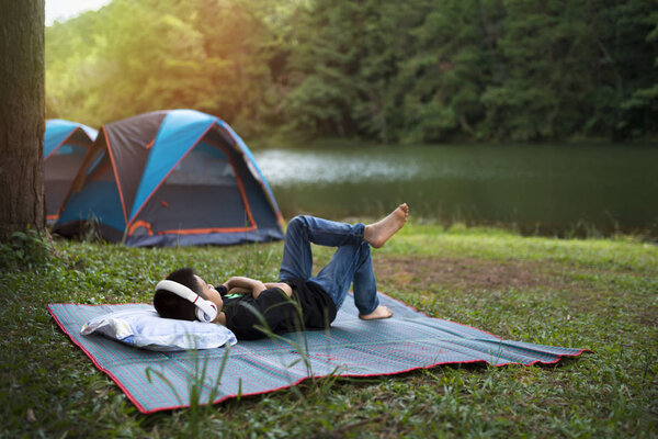 Holiday camping - Young boy resting on pallet