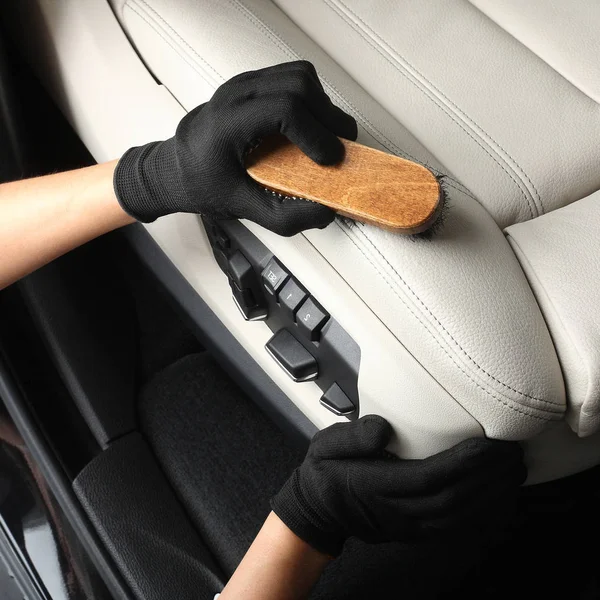 Car service. Worker washing of interior by a brush — Stock Photo, Image