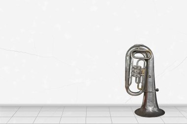 Home interior -   Vintage tuba in front of white wall clipart