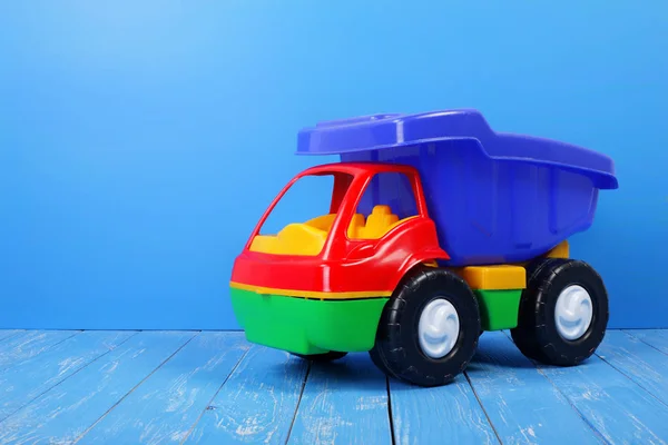 Camião de brinquedo caminhão de descarga em um fundo azul — Fotografia de Stock