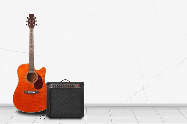 Home interior - Orange acoustic guitar, amplifier of white wall — Stock Photo, Image