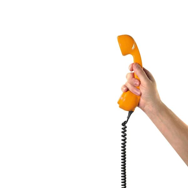 Objects Hands action - Hand holds retro orange phone red handset — Stock Photo, Image