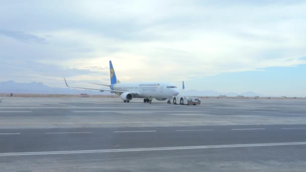 Ein Flugzeugschlepper setzt ein Flugzeug in Bewegung — Stockvideo