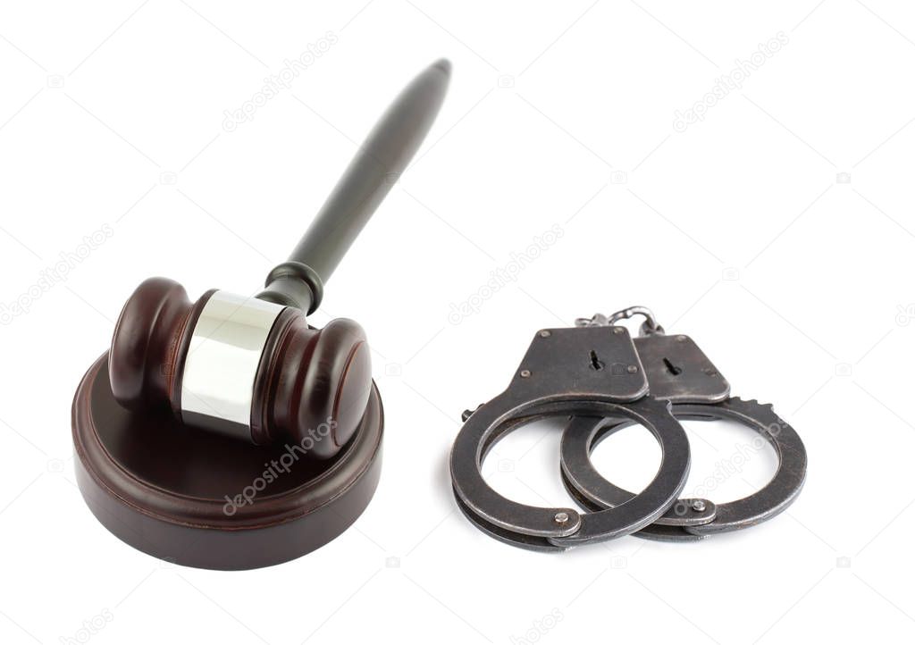 Wooden brown gavel and handcuffs