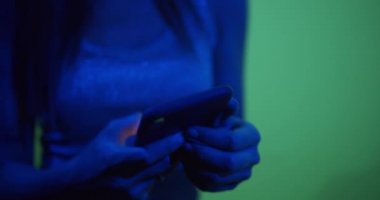 The girl corresponds in social networks in neon light