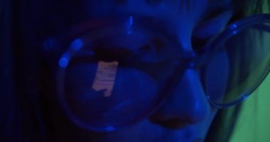 The girl corresponds in social networks in neon light