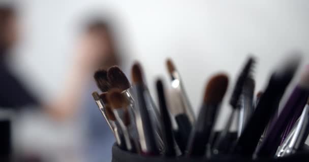 Visagiste toepassing van make-up op modellen gezicht — Stockvideo