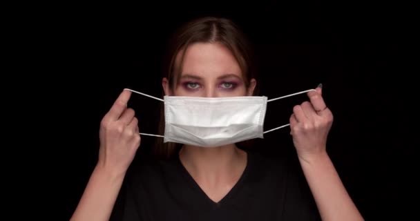 Woman Puts on Medical Mask Portrait — Stock Video