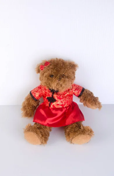 Toy or teddy bear with chinese red shirt on background. — Stock Photo, Image