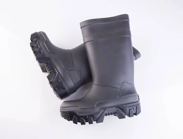 Παπούτσι ή μαύρο χρώμα καουτσούκ μπότες σε φόντο. — Φωτογραφία Αρχείου