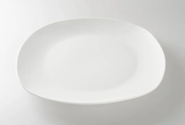 Placa o plato vacío sobre un fondo . — Foto de Stock