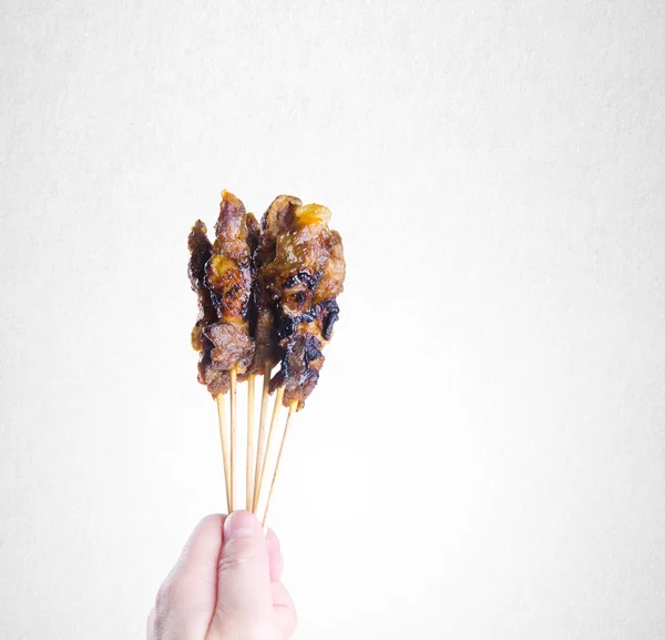 Satay or Hand Holding Sticks of a Barbecue Satay on background. — Stock Photo, Image