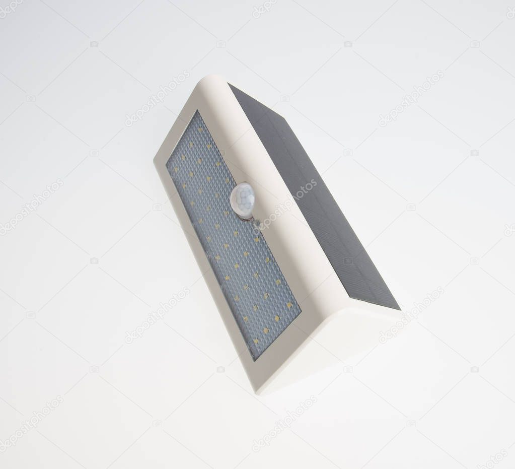 Solar LED lamp with motion sensor on a background