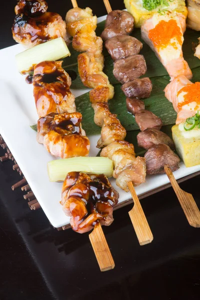 Japanese cuisine. grill stick on the background — Stock Photo, Image