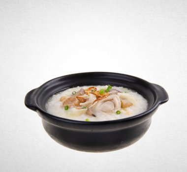 Yulaf lapası veya claypot bir arka plan üzerinde abalone püresi.