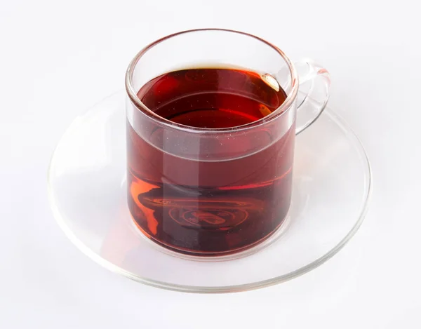 Tee in Glasschale auf einem Hintergrund. Tee im Glasbecher auf einem Background — Stockfoto