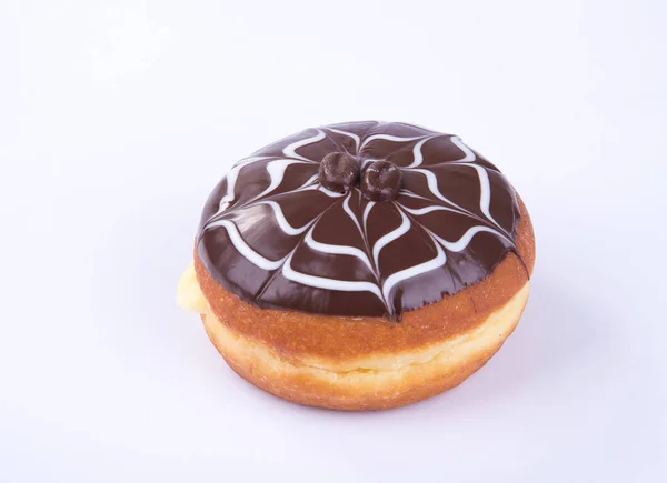 Dona o donut de chocolate sobre un fondo . Imágenes De Stock Sin Royalties Gratis