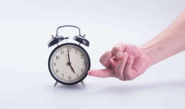 Alarm clock or alarm clock with hand on the background. — Stock Photo, Image