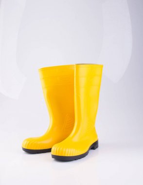shoe or yellow color rubber boots on a background. clipart
