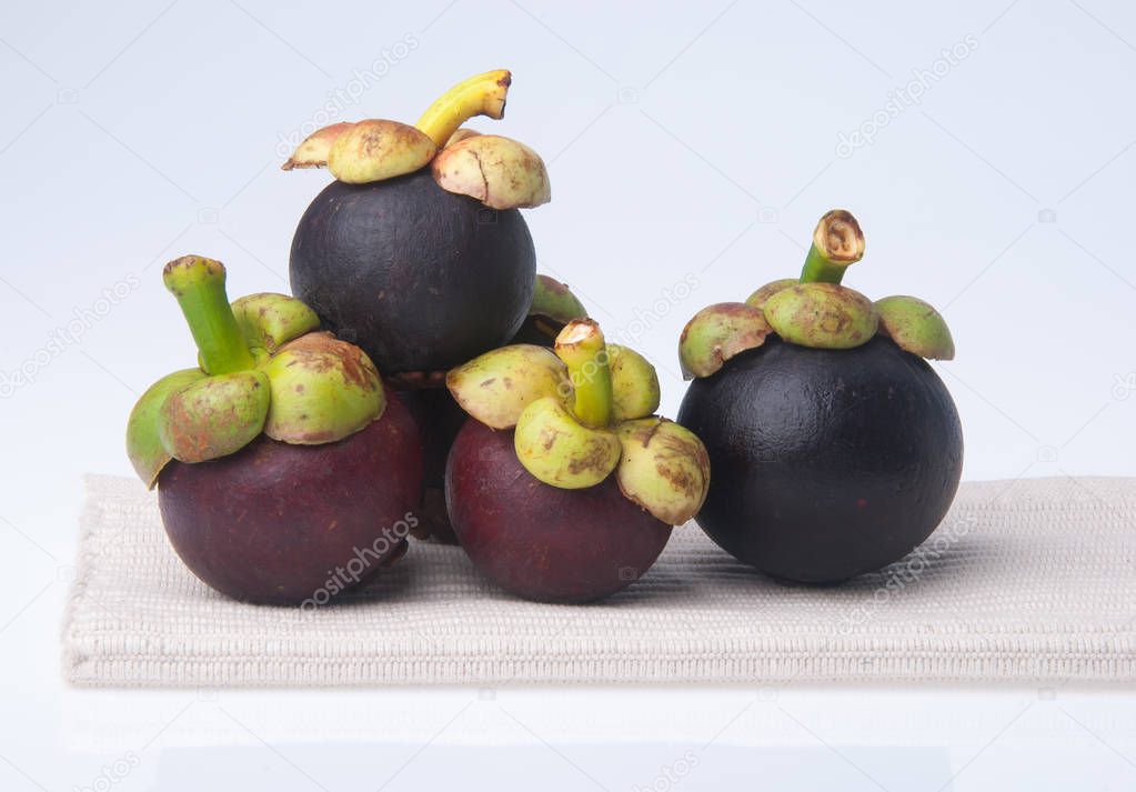 Mangosteen fruit and cross section showing the thick purple skin