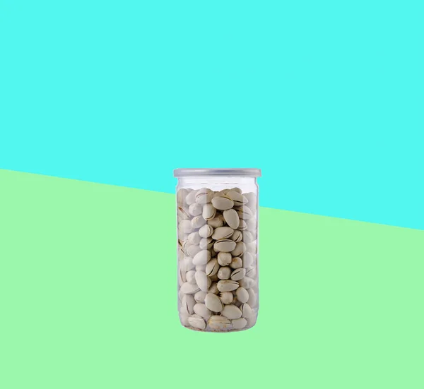 Pistachio nuts in jar on background — Stock Photo, Image