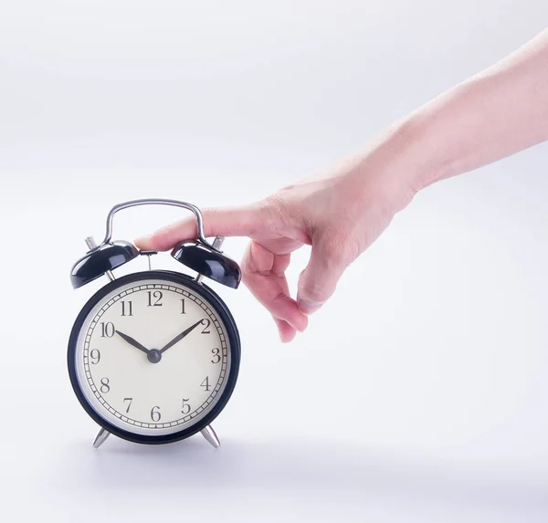 Clock or alarm clock with hand on a background new. — Stock Photo, Image