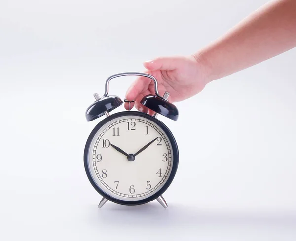 Clock or alarm clock with hand on a background new. — Stock Photo, Image