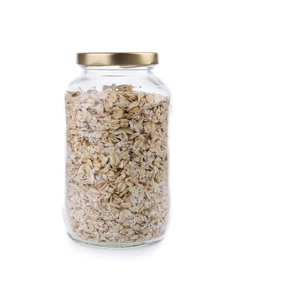 Oat flakes in a glass jar on a background new. — Stock Photo, Image