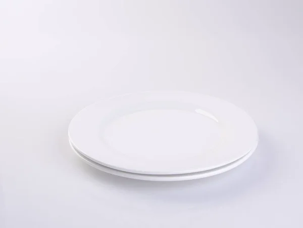 Plate or empty plate on a background new. — Stock Photo, Image