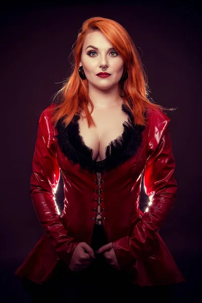 Attractive girl  hair in red latex jacket — Stock Photo, Image