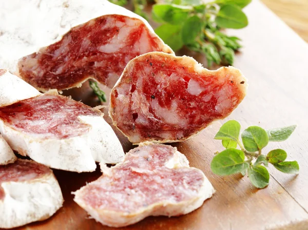 Smoked sausage delicacy salami on a wooden board — Stock Photo, Image