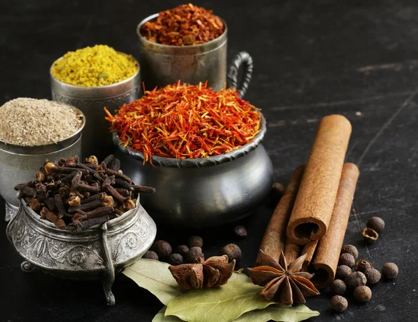 Assorted spices (saffron, pepper, turmeric, cinnamon) — Stock Photo, Image